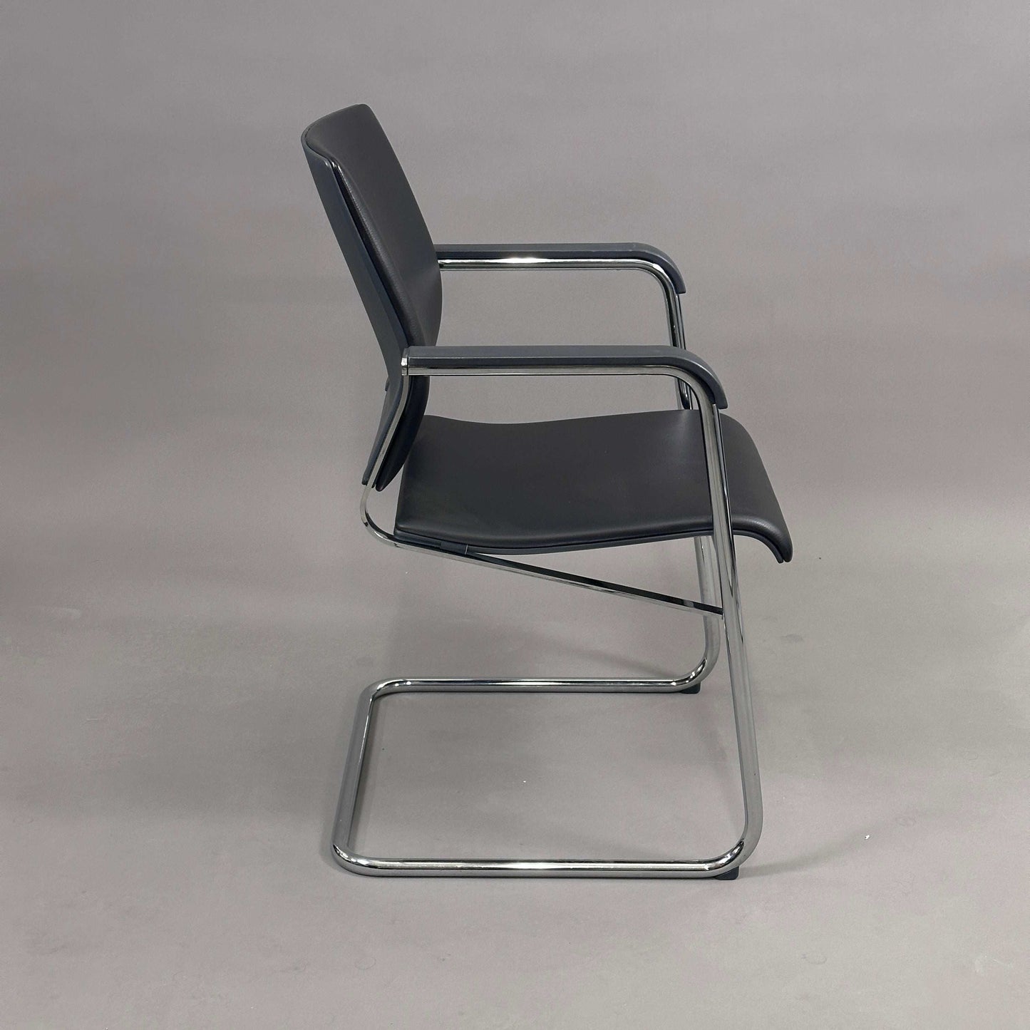 Wilkhahn Sito chair with black leather seat and chrome frame side view