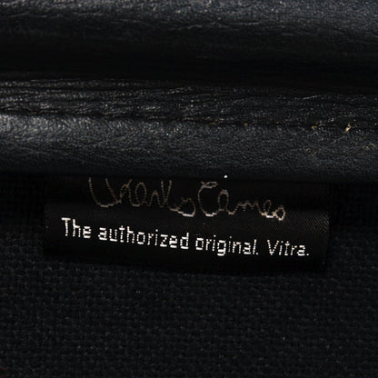 Vitra Charles Eames Soft Pad Chair label: "The authorized original. Vitra." on black leather.