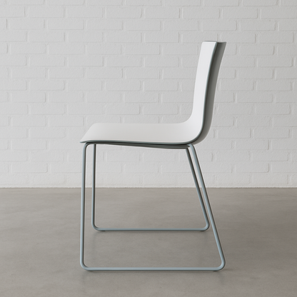 Arper Catifa 46 chair with white seat and blue sled base against white brick wall