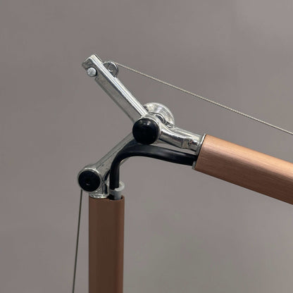 Close-up of Artemide Tolomeo Micro desk lamp in copper with adjustable arm and metal joints