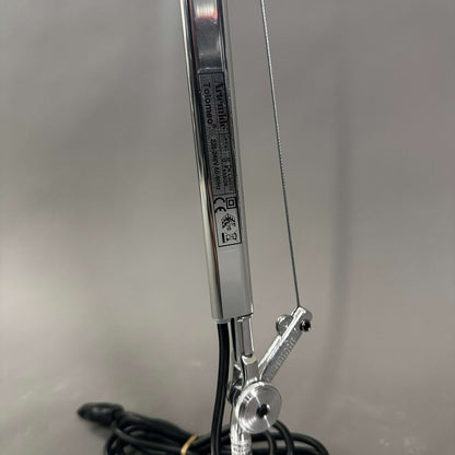 Close-up of polished aluminum Artemide Tolomeo Tavolo adjustable arm with cable and joint details