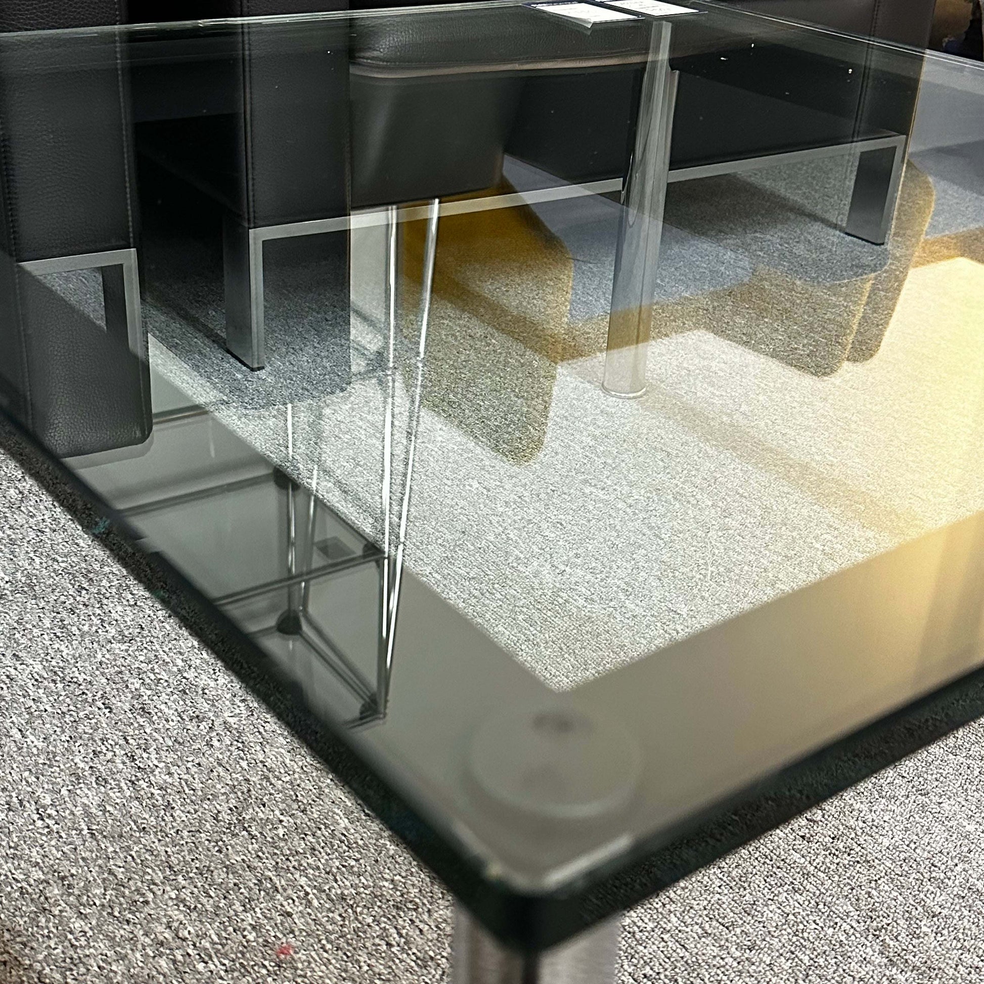 Close-up of Cassina LC10 glass coffee table with sleek transparent top and minimalist design