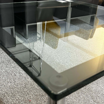 Close-up of Cassina LC10 glass coffee table with sleek transparent top and minimalist design