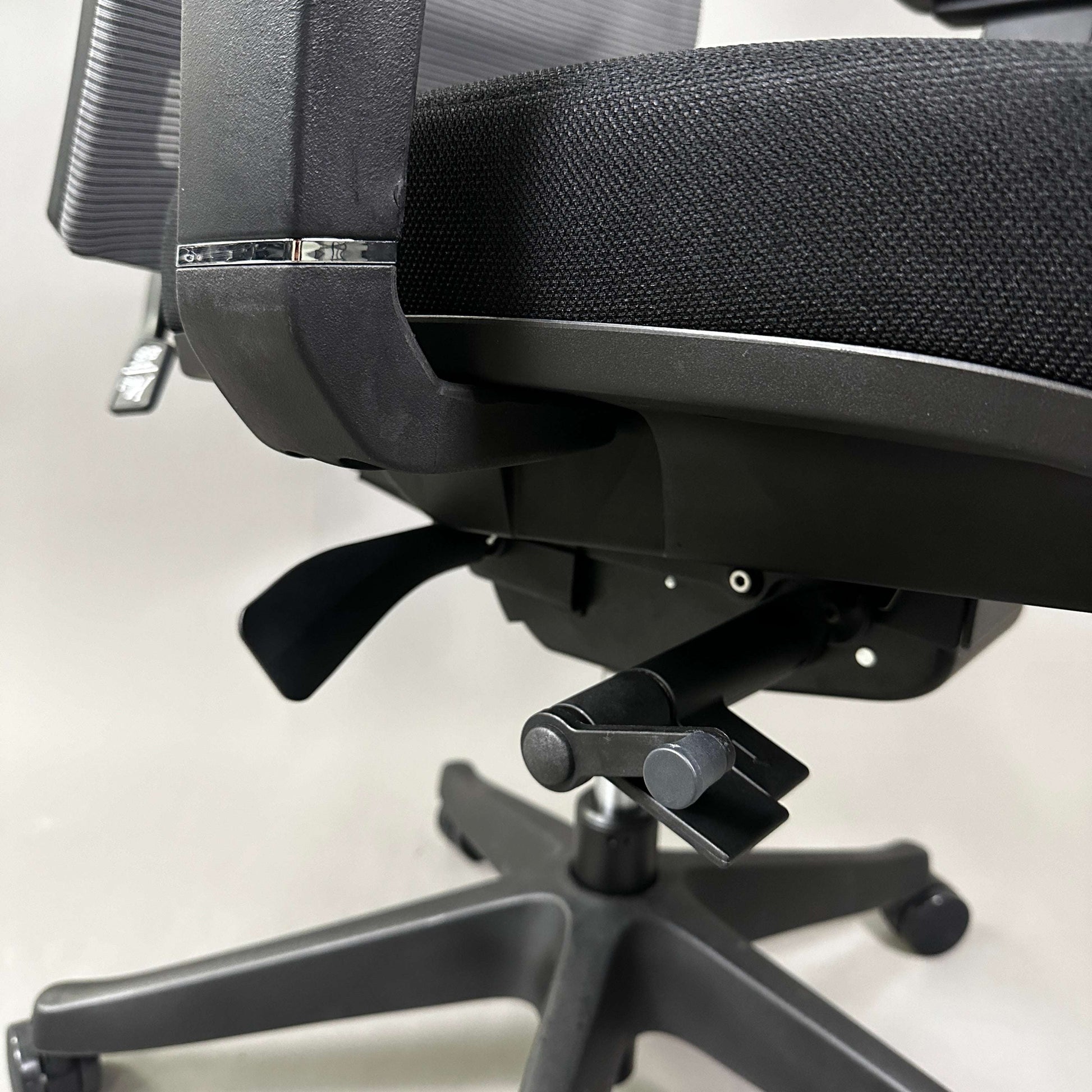 Close-up of black ergonomic office chair Ergo1 schwarz with adjustable controls and mesh backrest