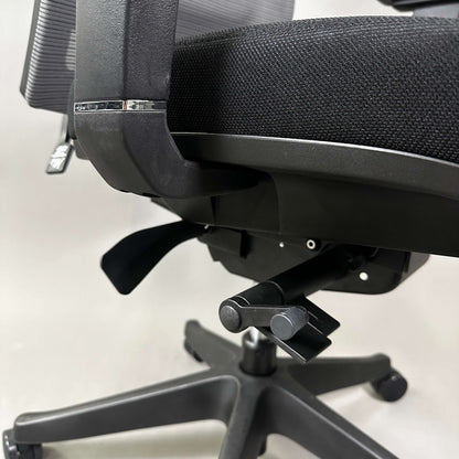 Close-up of black ergonomic office chair Ergo1 schwarz with adjustable controls and mesh backrest