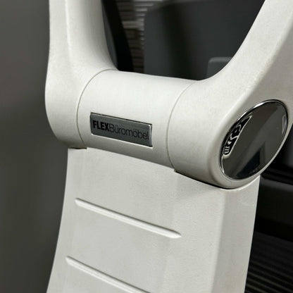 Close-up of white aluminum frame of ergonomic office chair with FLEX Büromöbel logo