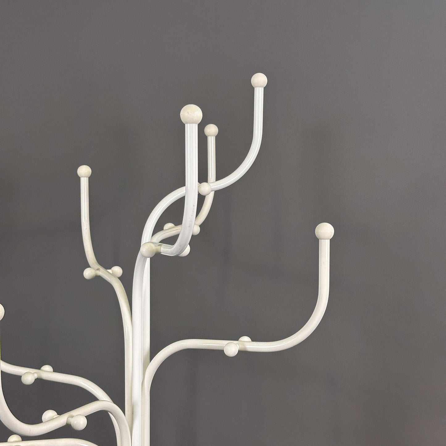 White Fritz Hansen Coat Tree with multiple hooks against a gray background