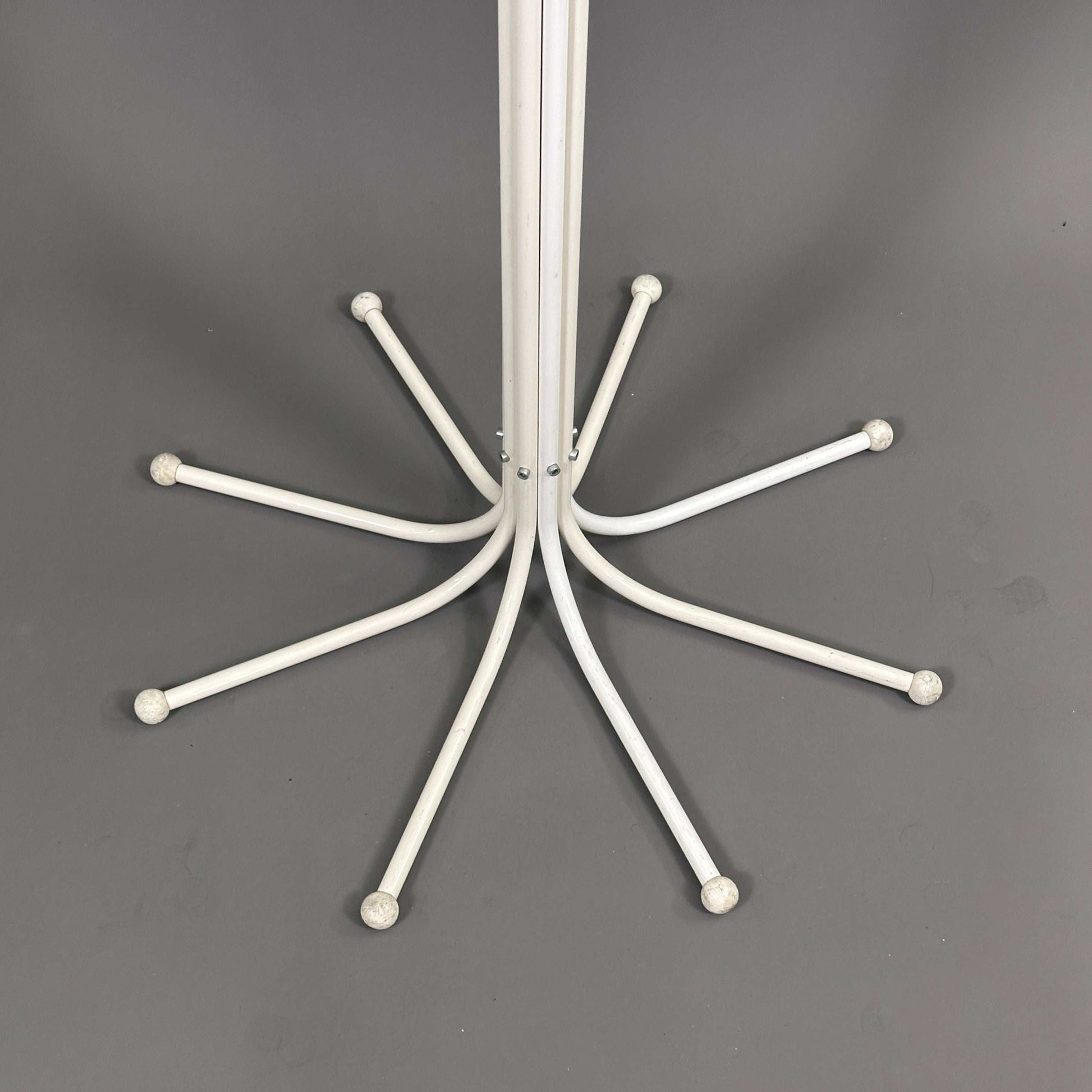 White Fritz Hansen Coat Tree stand with curved hooks on gray background