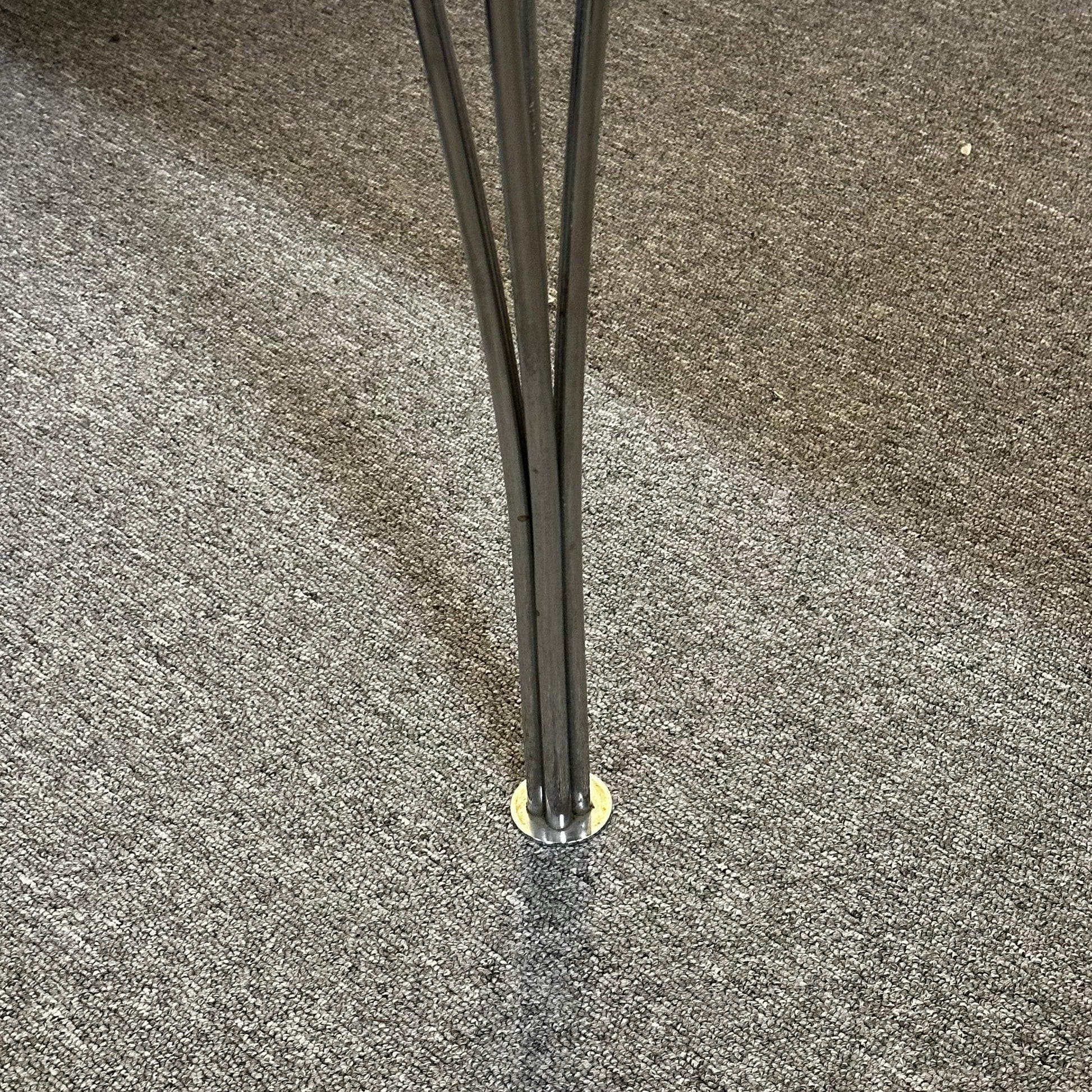 Close-up of Fritz Hansen Tisch metal leg on carpeted floor in 80x120cm dining or office table