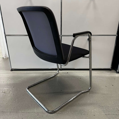 Haworth Comforto 29 visitor chair with ergonomic design, mesh backrest, and chrome cantilever frame.