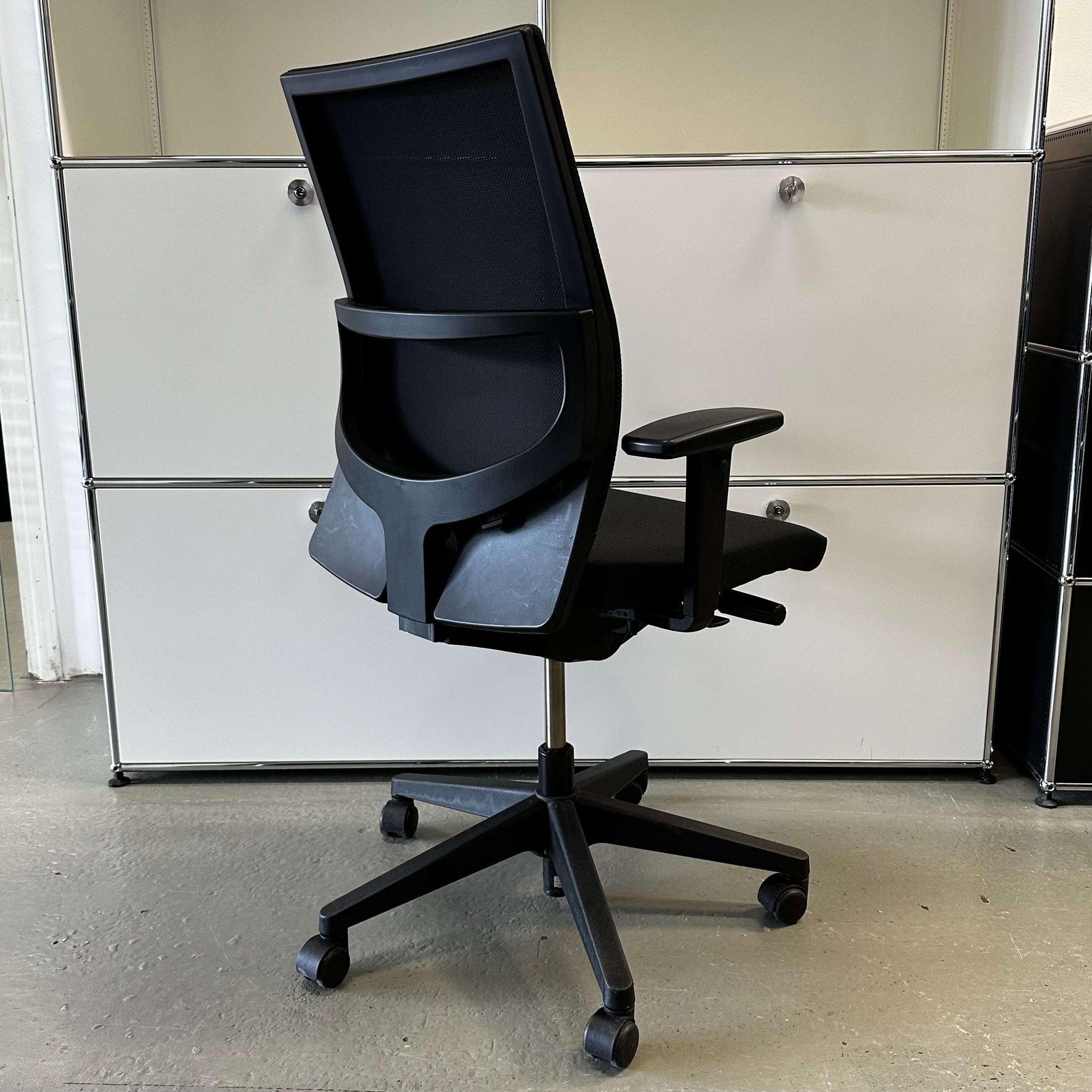 Haworth Comforto 39 black office chair with mesh backrest, adjustable armrests, height, and tilt, black fabric seat, and five-star base with casters