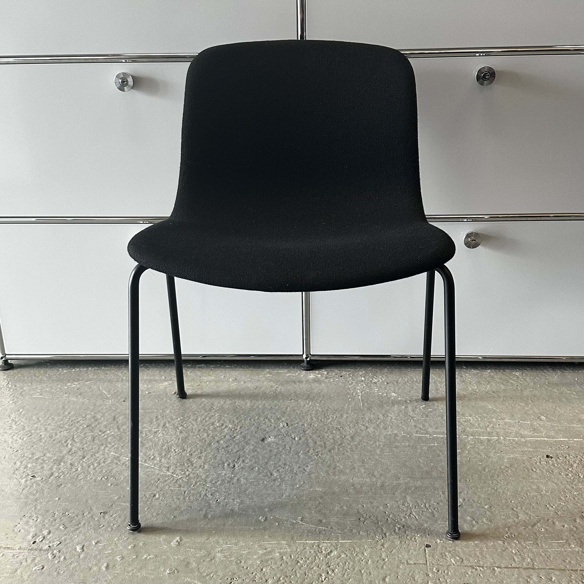 Black modern Hay Chair AAC 17 with sleek design and metal legs in minimalist room