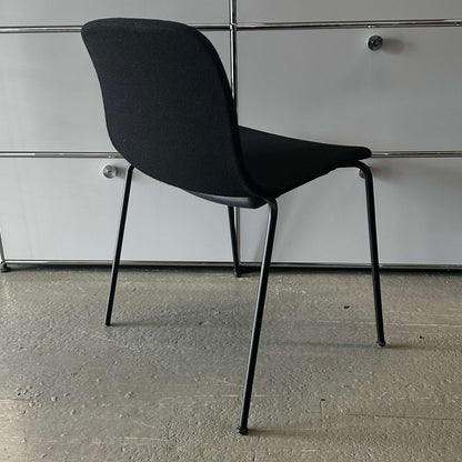 Modern black Hay Chair AAC 17 with sleek design and metal legs against a gray background