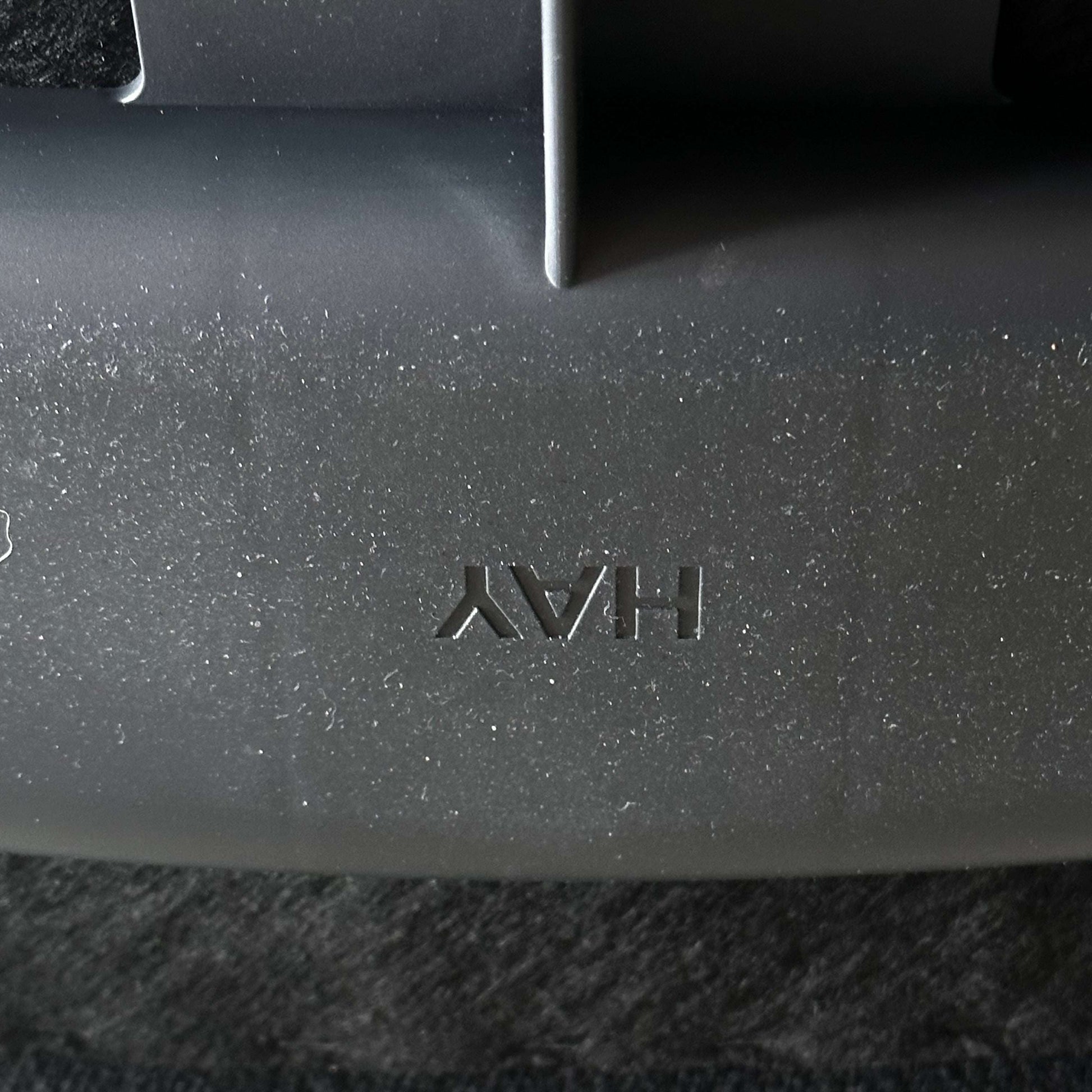 Close-up of black Hay Chair AAC 17 seat featuring embossed Hay logo and modern design details