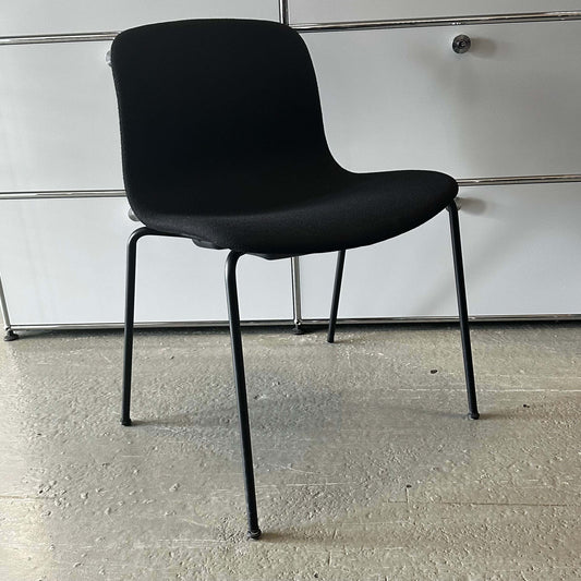 Modern black Hay Chair AAC 17 with sleek design and metal legs on concrete floor