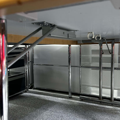 Underside view of a Klapptisch 160x80cm folding table with cream beige tabletop, metal hinges, and chrome legs.