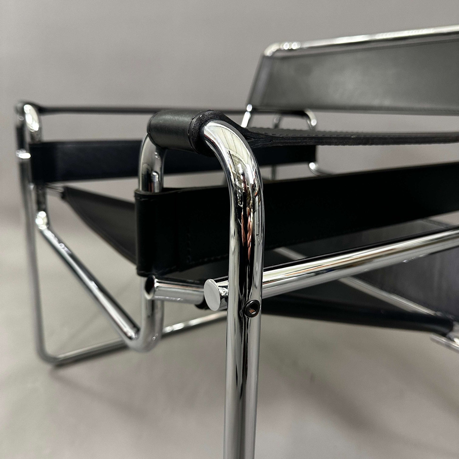 Close-up of a black leather Knoll Wassily Chair with chrome frame details