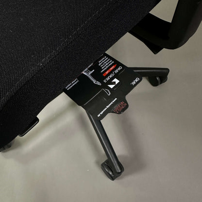 Close-up of König & Neurath Okay2 office chair base and adjustment labels