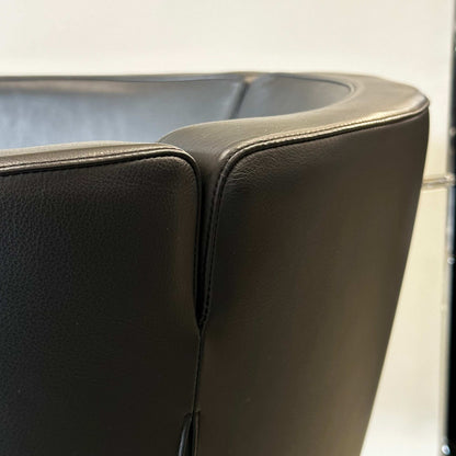 Close-up of black Living Divani Jelly leather armchair showcasing smooth upholstery and modern design details