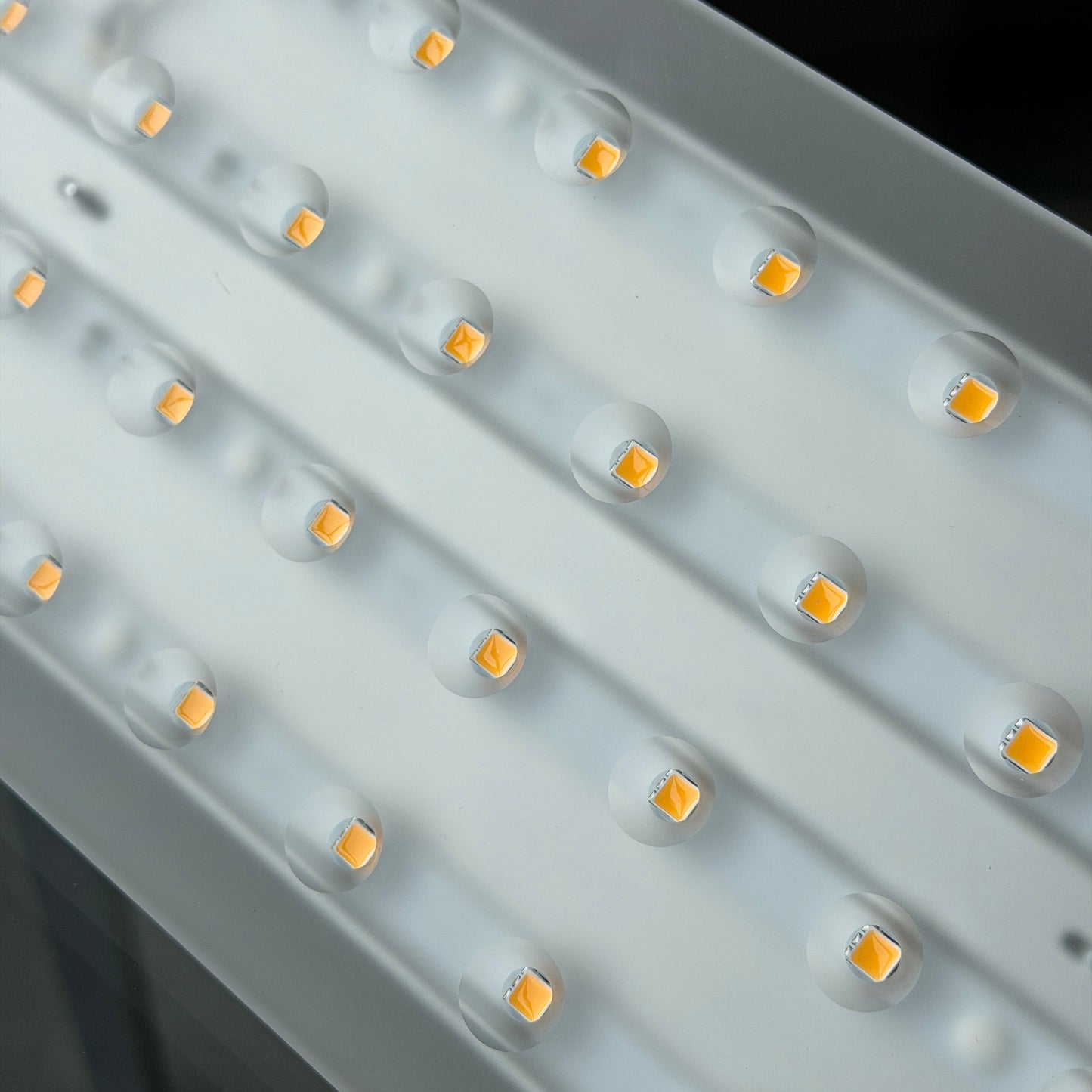 Close-up of a silver Nimbus LED ceiling light with a frosted diffuser and warm white LEDs.