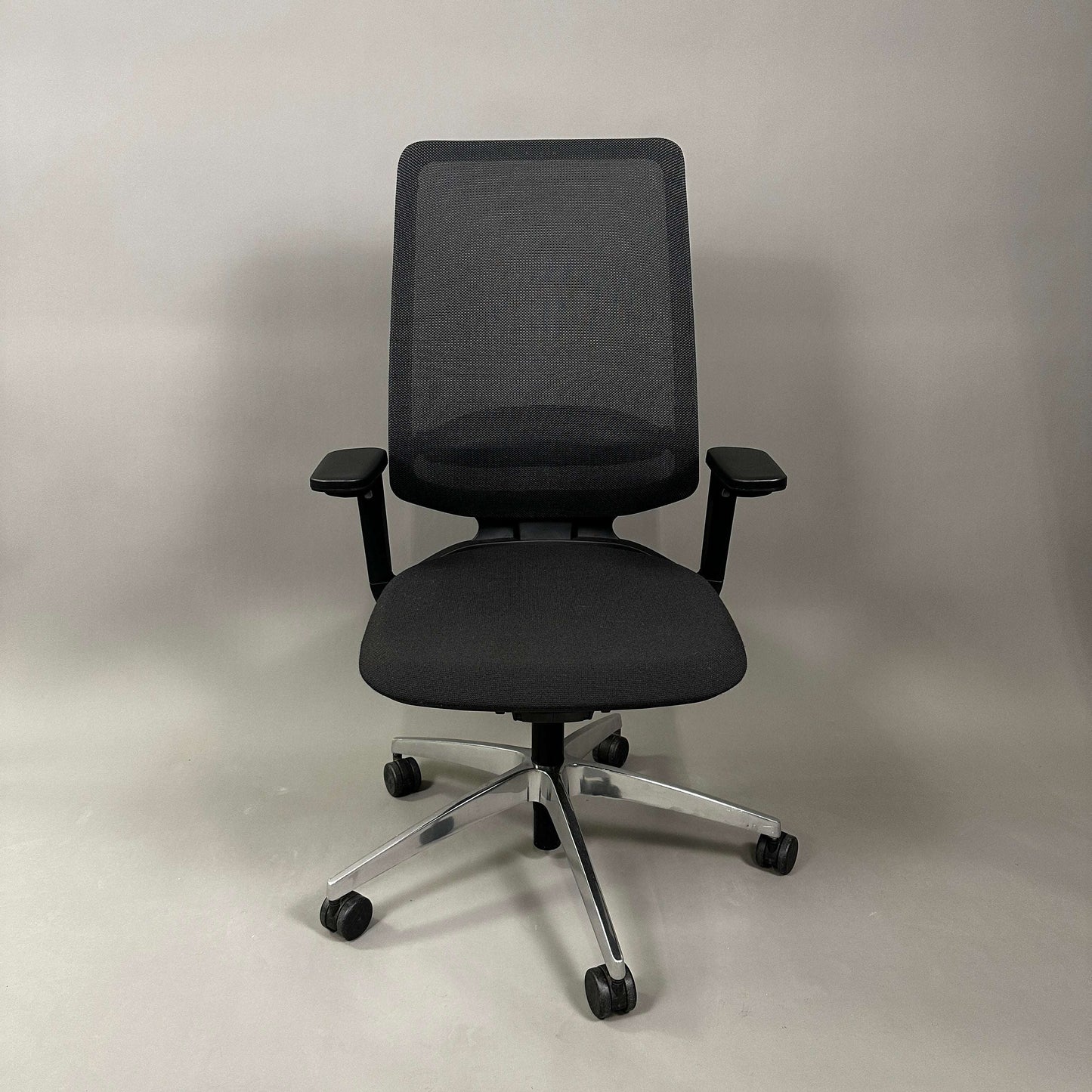 Black SEDUS se:flex office chair with adjustable seat height, 3D armrests, lumbar support, and hard floor casters