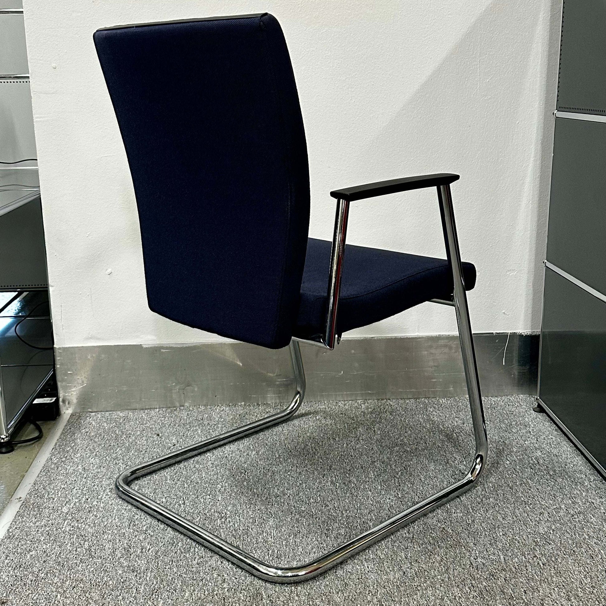 Sedus Freischwinger chair with ergonomic design, black seat and chrome cantilever frame.