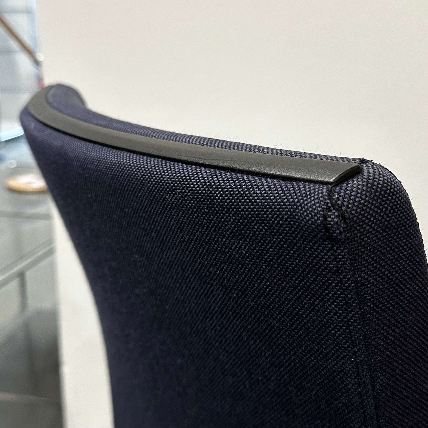 Close-up of the ergonomic black fabric backrest with plastic trim on the Sedus Freischwinger office chair