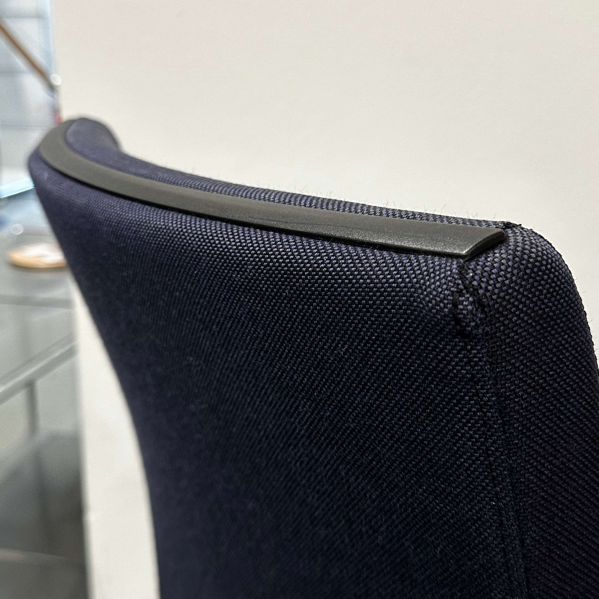 Close-up of the ergonomic black fabric backrest with plastic trim on the Sedus Freischwinger office chair