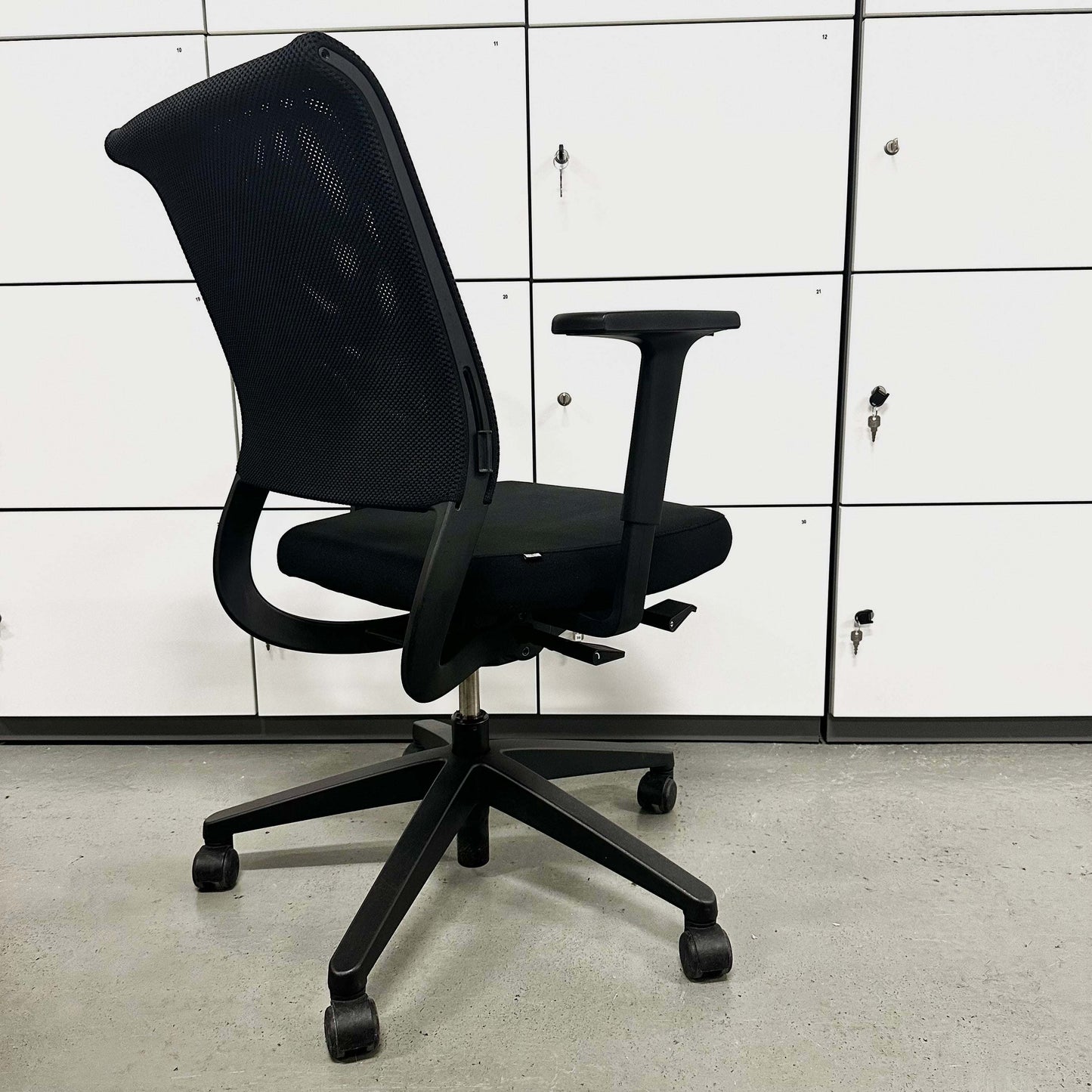 Sedus Netwin black office chair with mesh backrest, adjustable armrests, lumbar support, height adjustment, and black base with caster wheels.