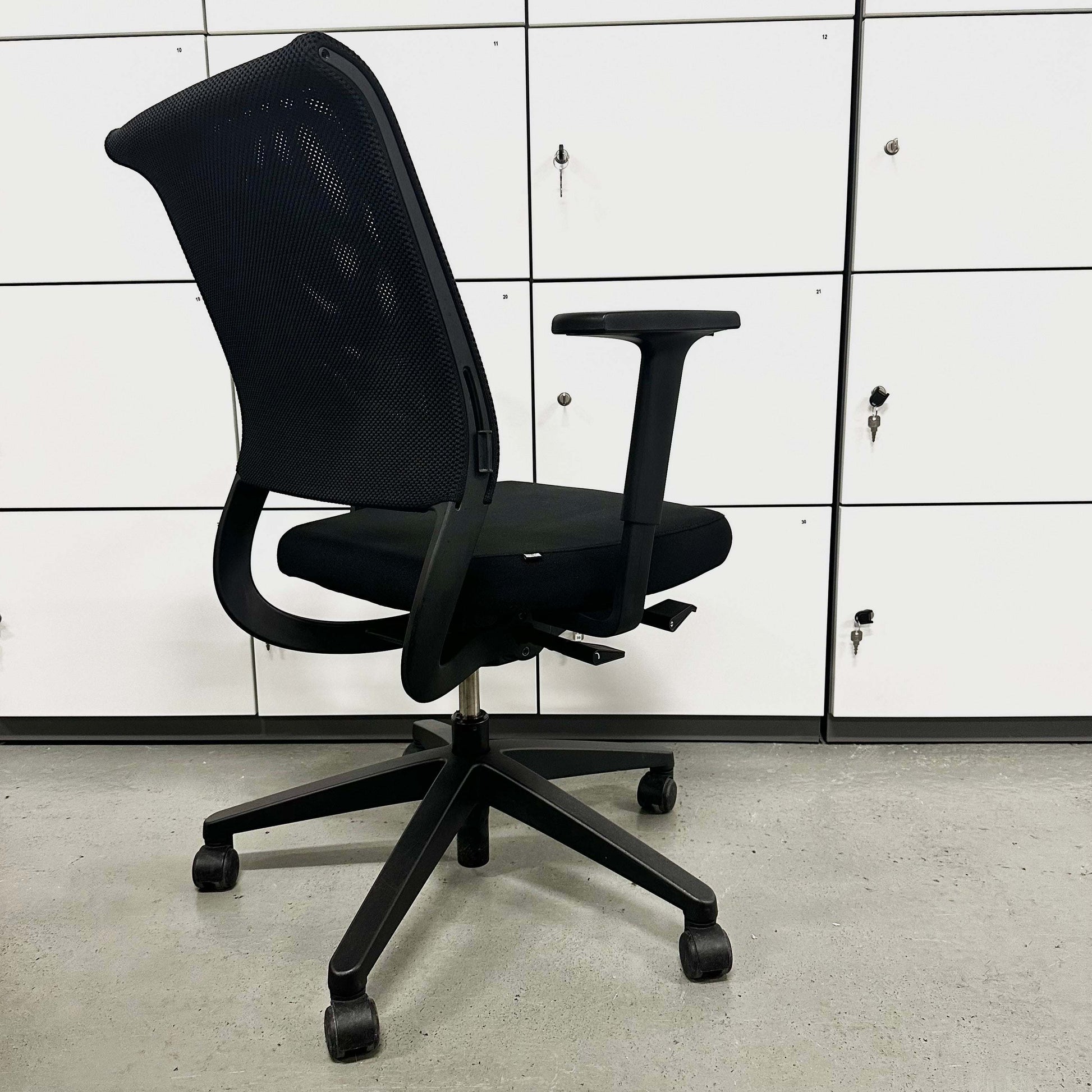 Sedus Netwin black office chair with mesh backrest, adjustable armrests, lumbar support, height adjustment, and black base with caster wheels.