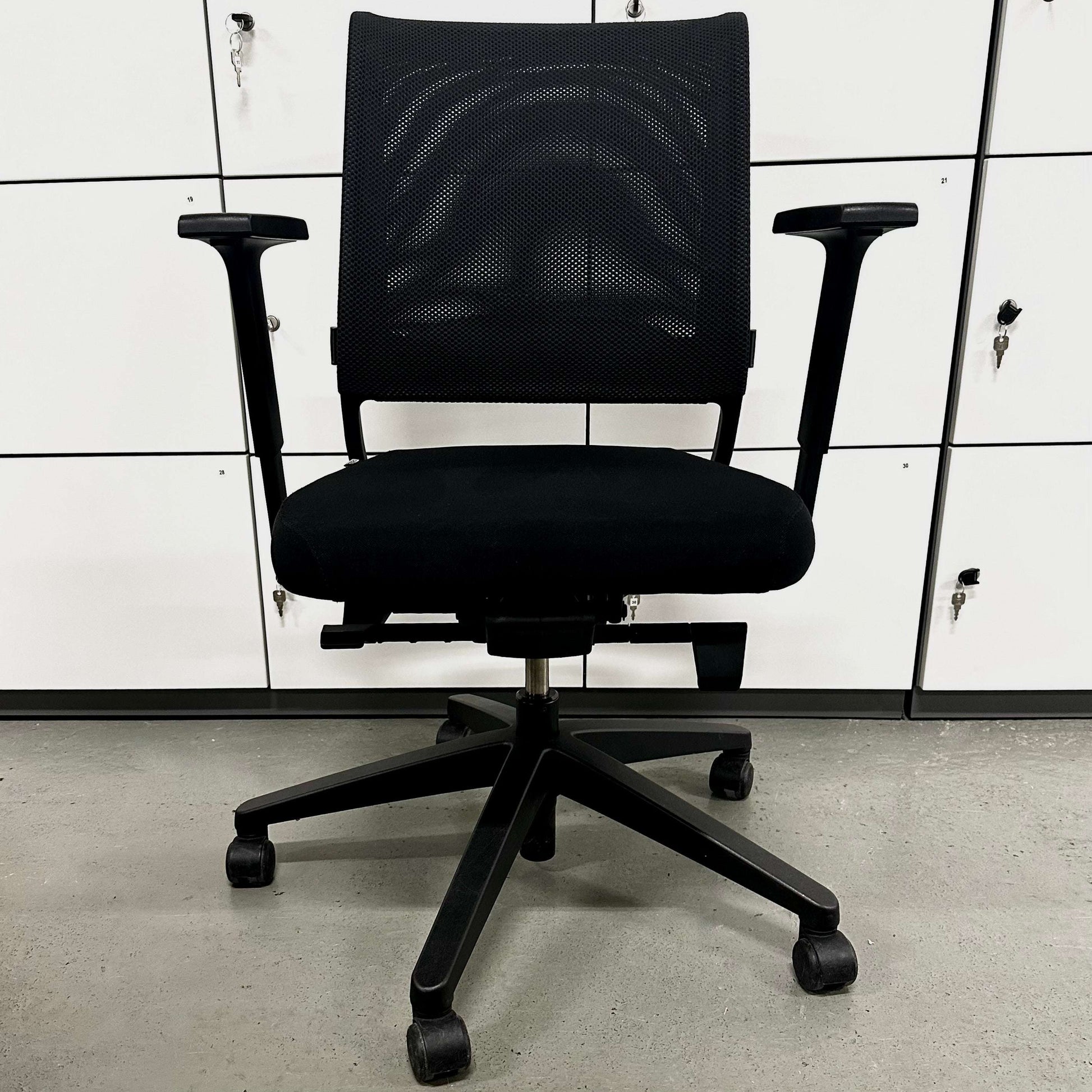 Sedus Netwin black ergonomic office chair with mesh back, adjustable armrests, lumbar support, and black base with caster wheels