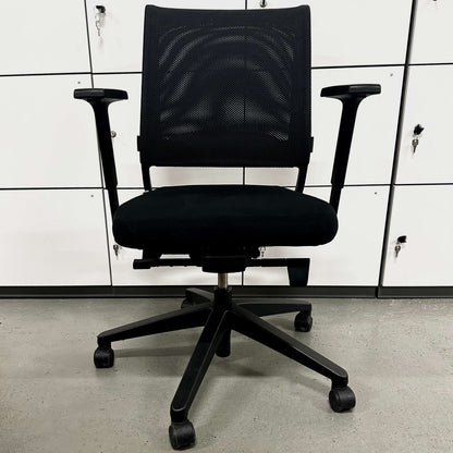 Sedus Netwin black ergonomic office chair with mesh back, adjustable armrests, lumbar support, and black base with caster wheels