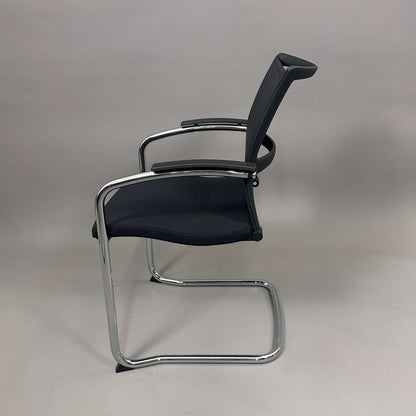 Sedus OpenUp Freischwinger chair with black mesh backrest and chrome cantilever frame