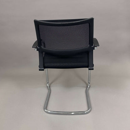 Sedus OpenUp Freischwinger chair with black mesh backrest and chrome cantilever frame viewed from the back