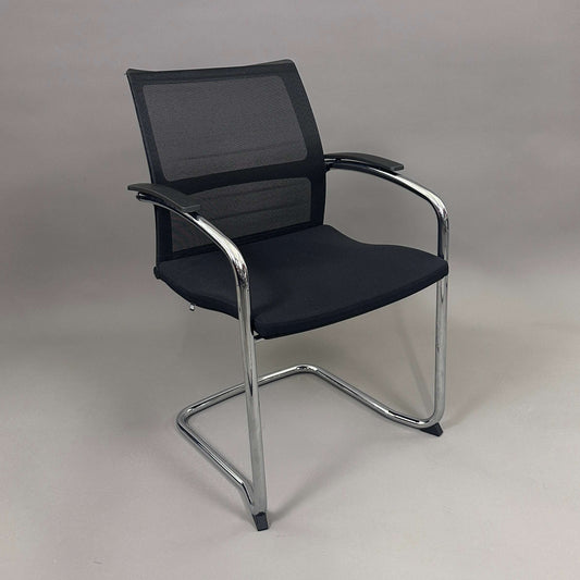 Sedus OpenUp Freischwinger chair with black mesh backrest, padded seat, and chrome cantilever frame
