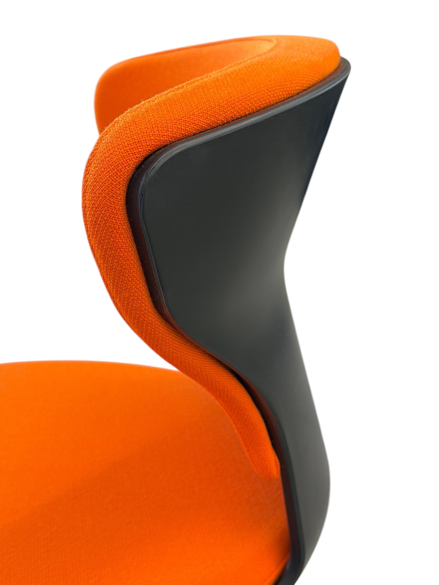 Close-up of an orange fabric Sedus Turn Around 181 high desk chair with a black polypropylene back.