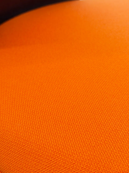 Close-up of vibrant orange fabric texture on a Sedus Turn Around 181 high desk chair.
