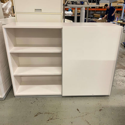 White sideboard 120cm with three open shelves and one closed cabinet door in a workshop setting