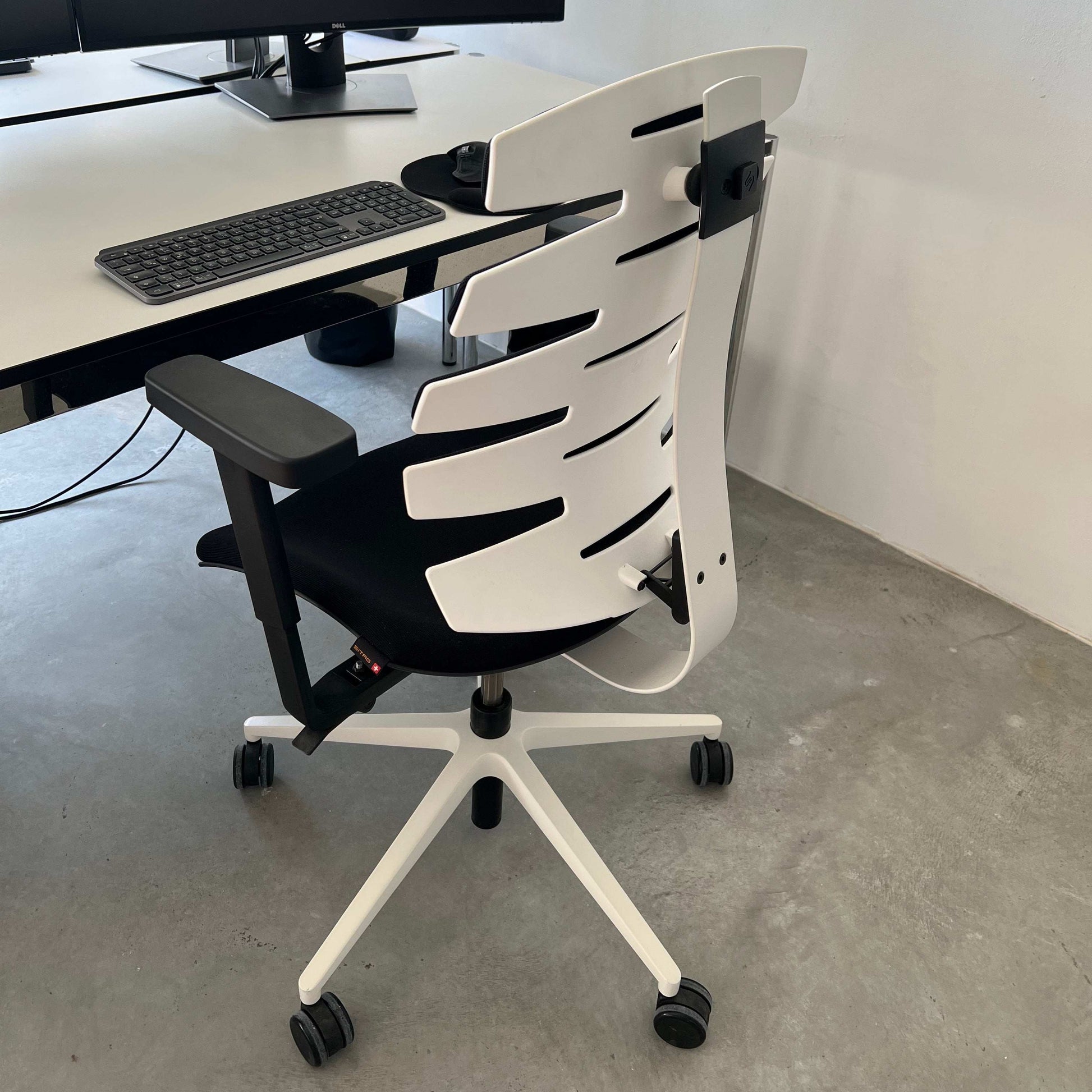 Sitag Wave ergonomic office chair with black upholstery, white frame, adjustable height, depth suspension, 3D soft padded armrests, and adjustable backrest angle.