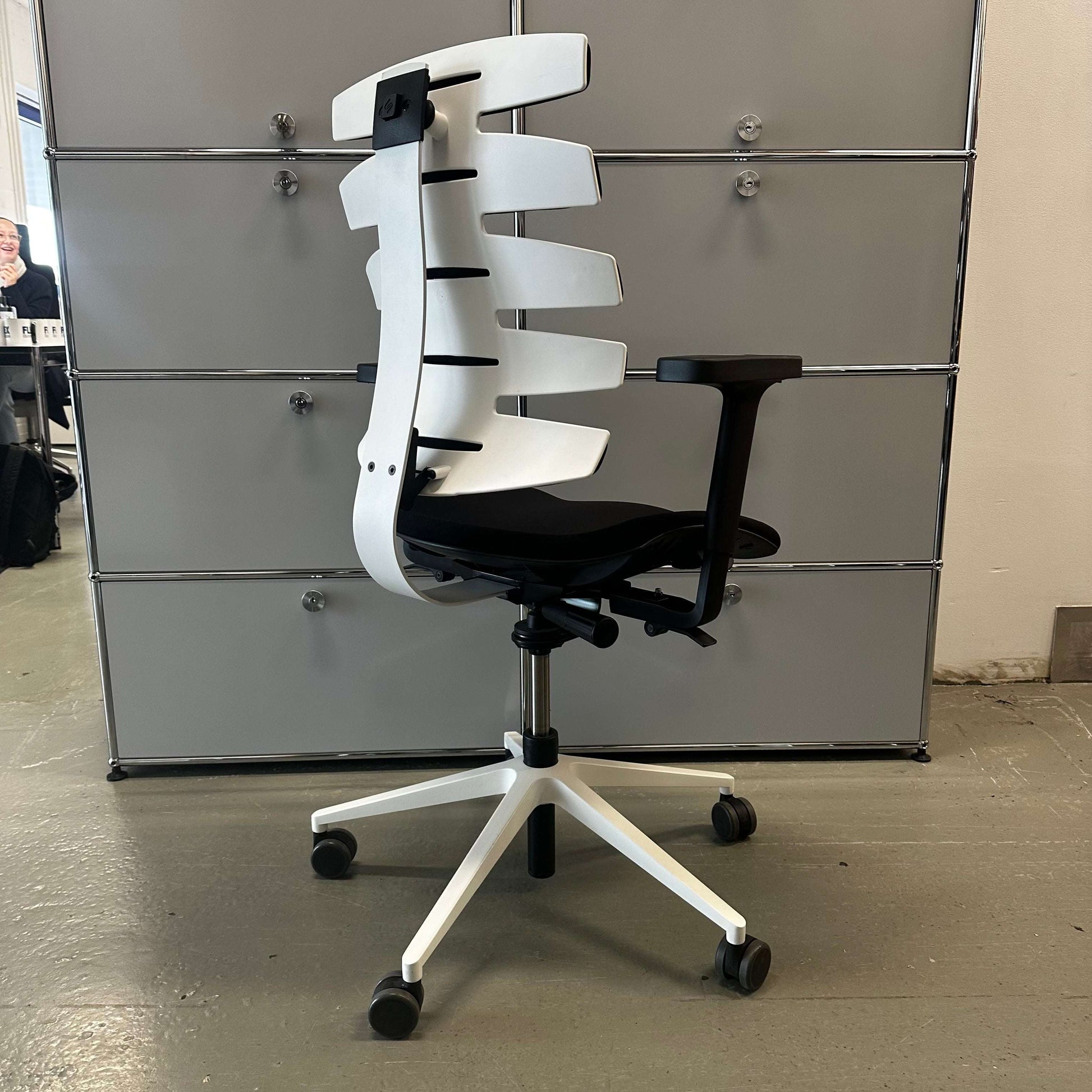 Sitag Wave ergonomic office chair with black upholstery, white frame, adjustable height, depth suspension, 3D soft-pad armrests, and adjustable backrest angle and height.