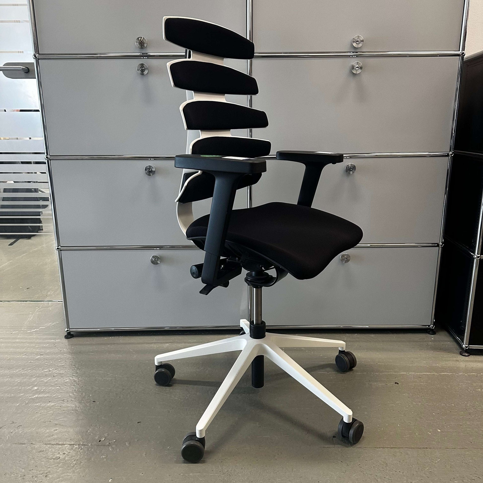 Sitag Wave ergonomic office chair with black upholstery, white frame, adjustable height, 3D armrests with soft pads, and adjustable seat and backrest angle