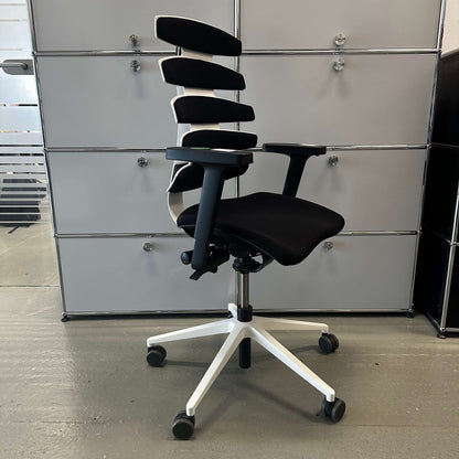 Sitag Wave ergonomic office chair with black upholstery, white frame, adjustable height, 3D armrests with soft pads, and adjustable seat and backrest angle