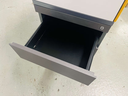 Steelcase Anstellcontainer with anthracite wood body, white upper section, and open drawer on light floor