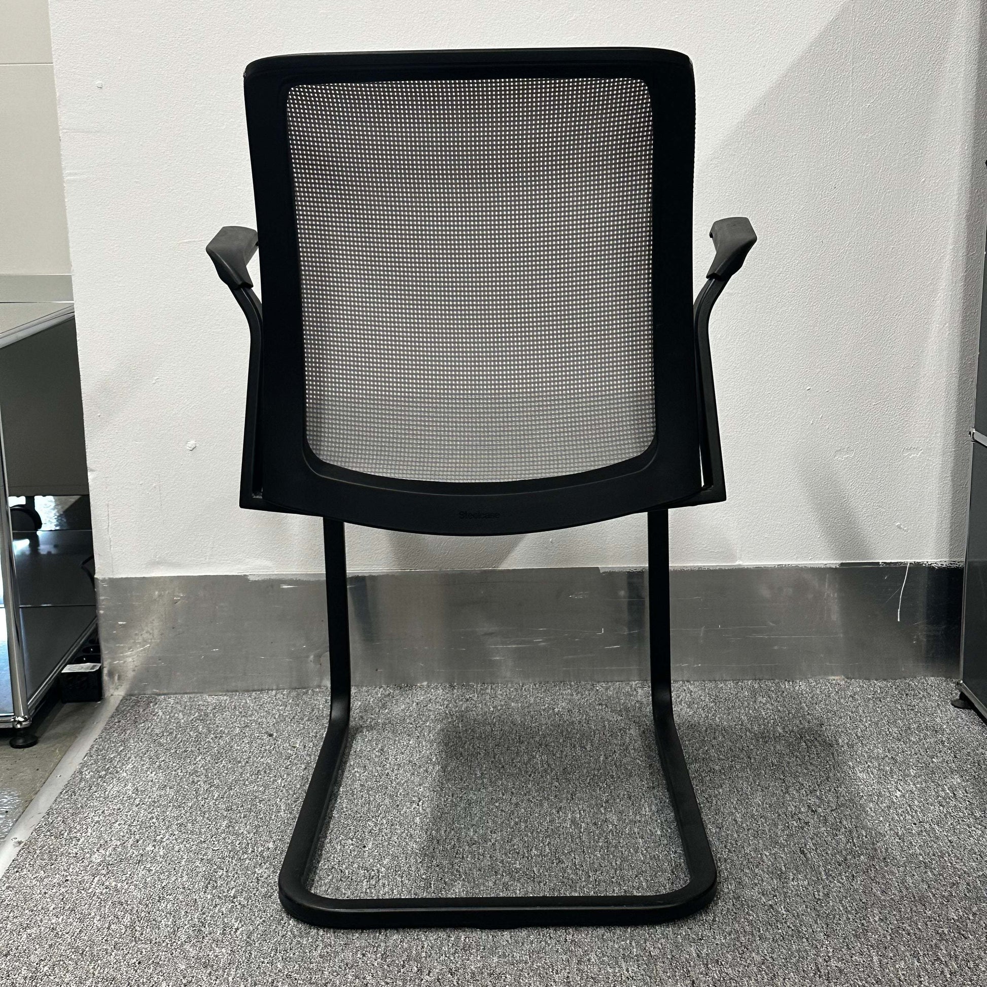 Steelcase Eastside Freischwinger black mesh office chair with cantilever base and ergonomic design viewed from the back