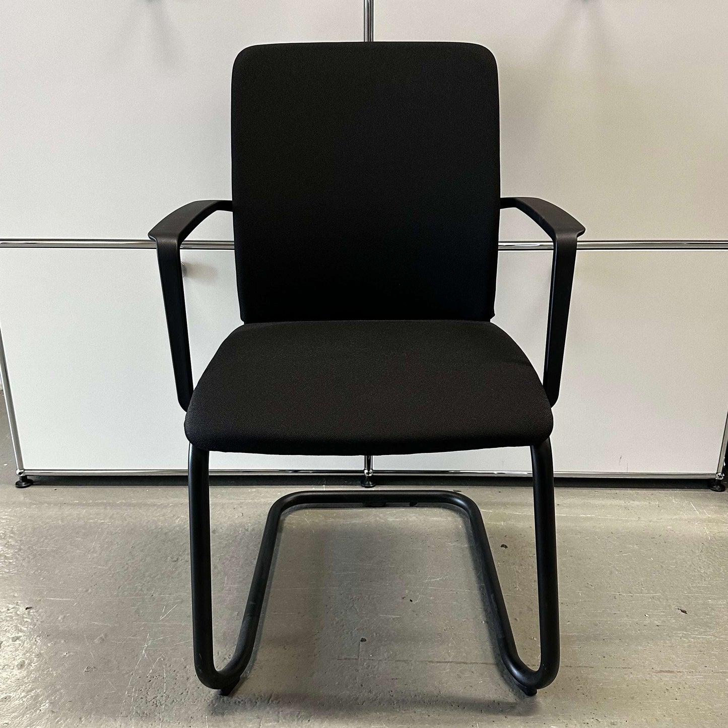 Steelcase Northside black upholstered stackable meeting chair with armrests and black frame