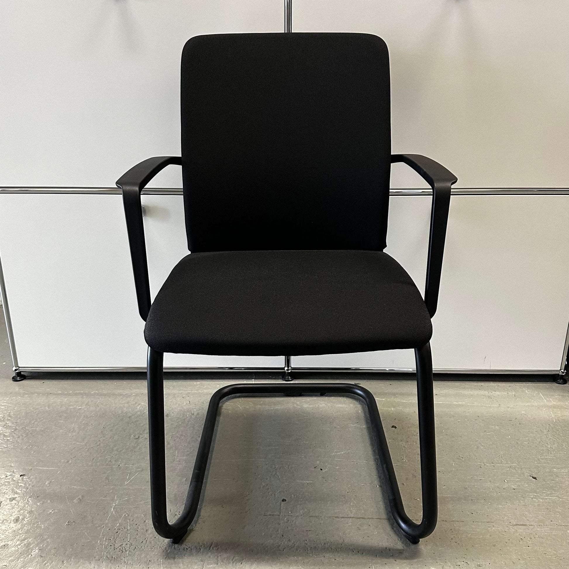 Steelcase Northside black upholstered stackable meeting chair with armrests and black frame