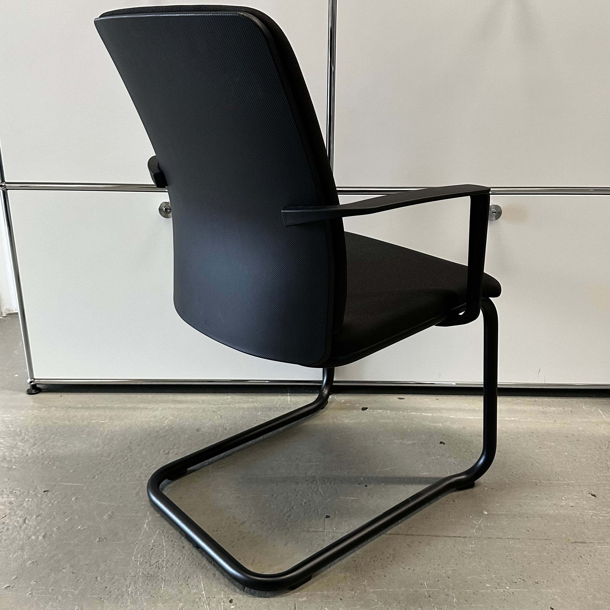 Steelcase Northside black meeting chair with padded back and cantilever frame