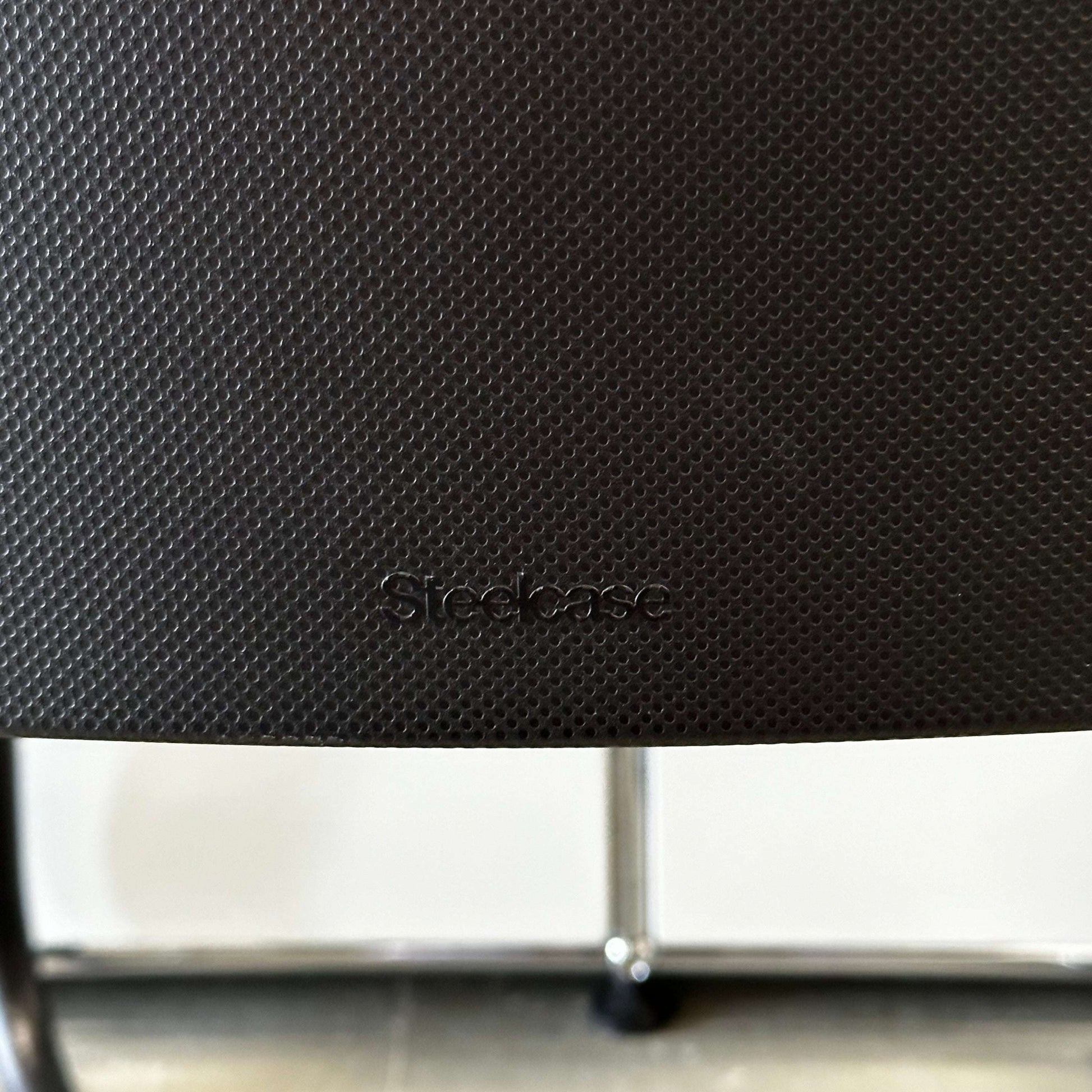 Steelcase Northside black meeting chair with textured backrest and black frame, stackable office seating