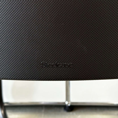 Steelcase Northside black meeting chair with textured backrest and black frame, stackable office seating