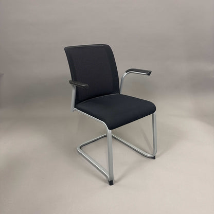 Steelcase Northside meeting chair with black mesh back and silver frame, stackable office chair